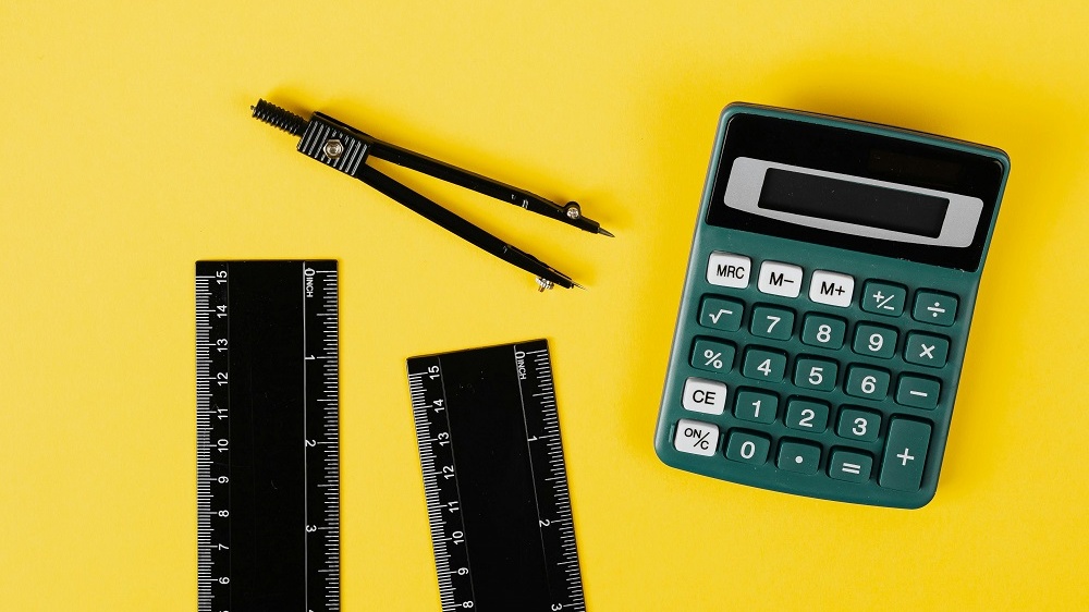 Image of a calculator and ruler, used in a template that tests an individual's knowledge in math.