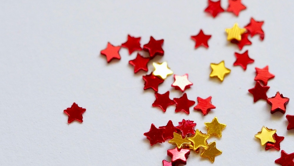 Image showing red star confetti on a white background, used in a Buzzfeed-style trivia quiz template.